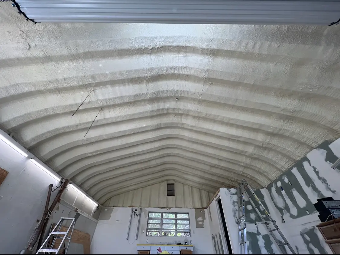 Spray polyurethane foam applied to the underside of a metal roof deck in Everman